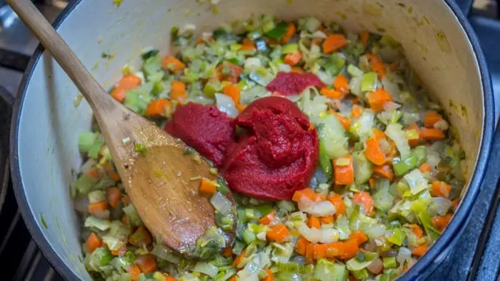 After the leeks, carrots and celery have softened, you add some tomato paste, and allow it to darken and caramelize.