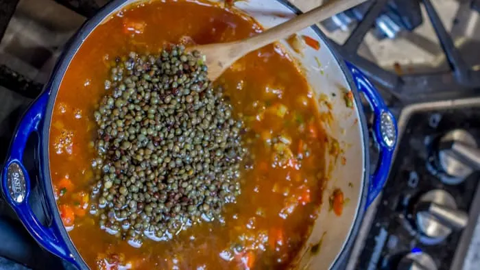 Adding the lentils to the soup base.