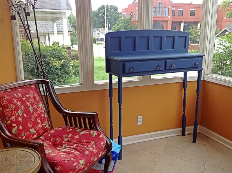 The blue table is Henry's perch, from which she watches the people and cars of Music Row. The chair is her nest - note the indentation.