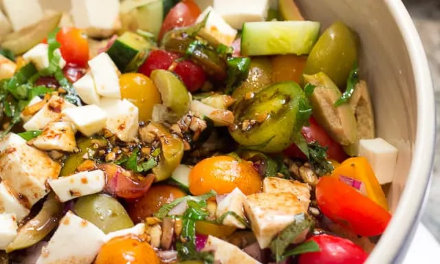 Panzanella is SCRUMPTIOUS! It's a traditional Italian bread salad recipe, and the best use of fresh summer tomatoes, fresh mozzarella, basil, and a balsamic vinaigrette I know! 