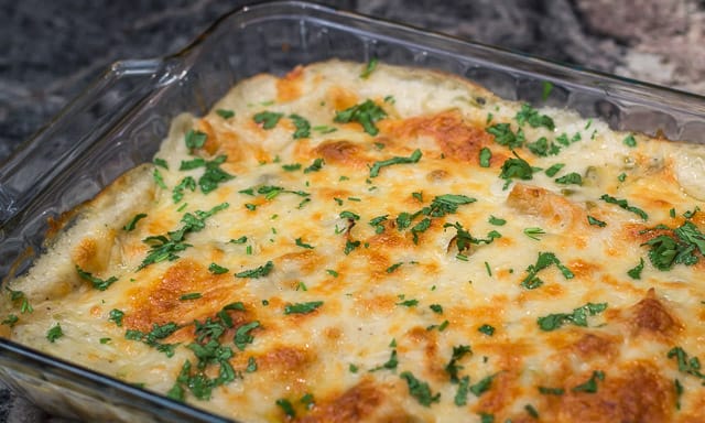 Easy, cheesy, creamy Tex-Mex comfort food! Sour Cream and Green Chile Enchiladas are a Family Favorite. #easy #cheesy #creamy #TexMex #CincodeMayo #enchiladas