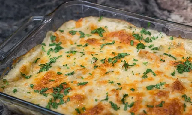 Easy, cheesy, creamy Tex-Mex comfort food! Sour Cream and Green Chile Enchiladas are a Family Favorite. #easy #cheesy #creamy #TexMex #CincodeMayo #enchiladas