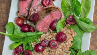 Easy, yet delicious enough for a gourmet palate: Grilled Bacon-Wrapped Venison Backstrap with Balsamic Cherries and Farro #grilling #venison #tenderloin #backstrap #baconwrappedvenison