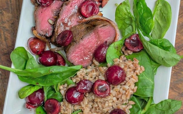 Easy, yet delicious enough for a gourmet palate: Grilled Bacon-Wrapped Venison Backstrap with Balsamic Cherries and Farro #grilling #venison #tenderloin #backstrap #baconwrappedvenison