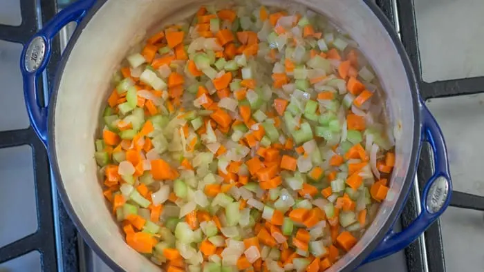 Sautéing the carrots and celery with the onion.