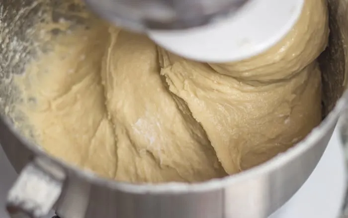 Knead dough with dough hook until it's smooth, elastic, and begins to clean the side of the bowl, 6 to 8 minutes. 