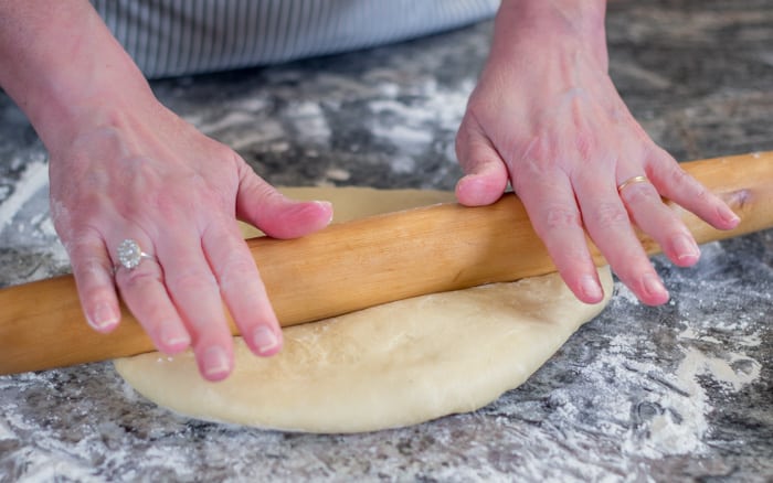 After the dough has risen, divide it in half, and roll each half into a 15" circle.