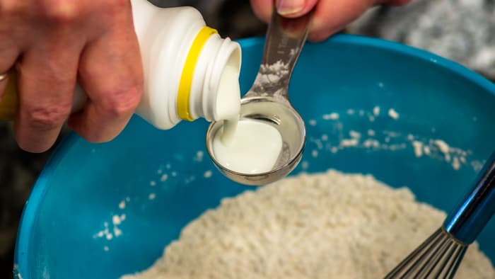 Adding a bit of buttermilk to the flour may sound surprising, but it's an important step.