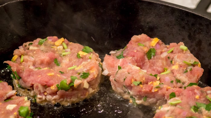 Beginning to fry the juicy smashed turkey burgers.