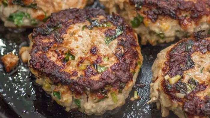 Frying the smashed burgers.