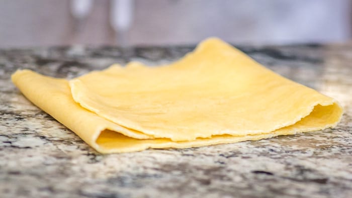 After the first pass through the machine, fold your dough into thirds, and then feed it through the widest setting of the roller again, a few more times. 