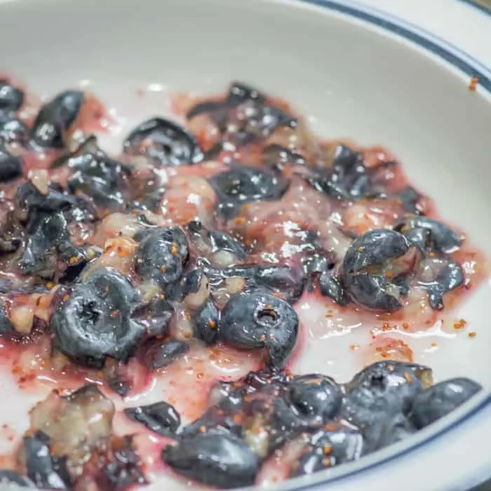 Smashed up blueberries in a bowl.