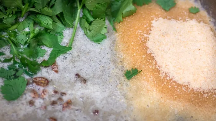 The rice, and herbs and spices being toasted in butter.