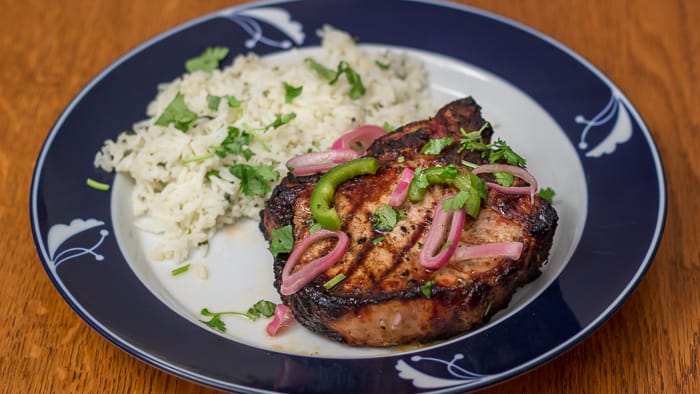Easy Cilantro Lime Rice, plated with Jalapeño Cilantro Grilled Pork Chops