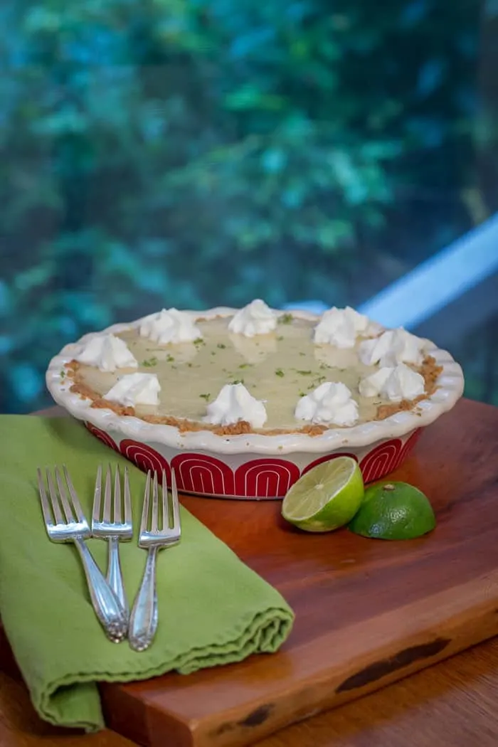 Key Lime Pie decorated with squirts of fresh whipped cream.