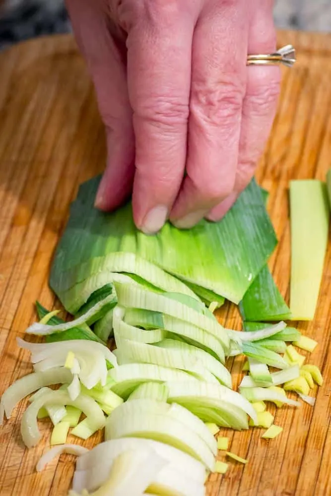 Flat side down, chop the leeks into little half moons.