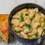 Permalink to: How to Make the Best White Beans Recipe How to Make the Best White Beans, with a slice of cornbread.