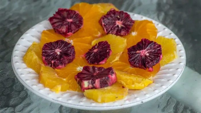 Arranging the Winter Citrus Salad Citrus Slices on a platter.