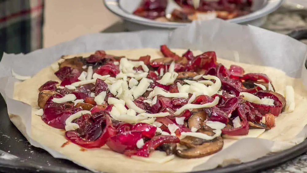 Applying the cheese. We're ready to go in the oven, now.