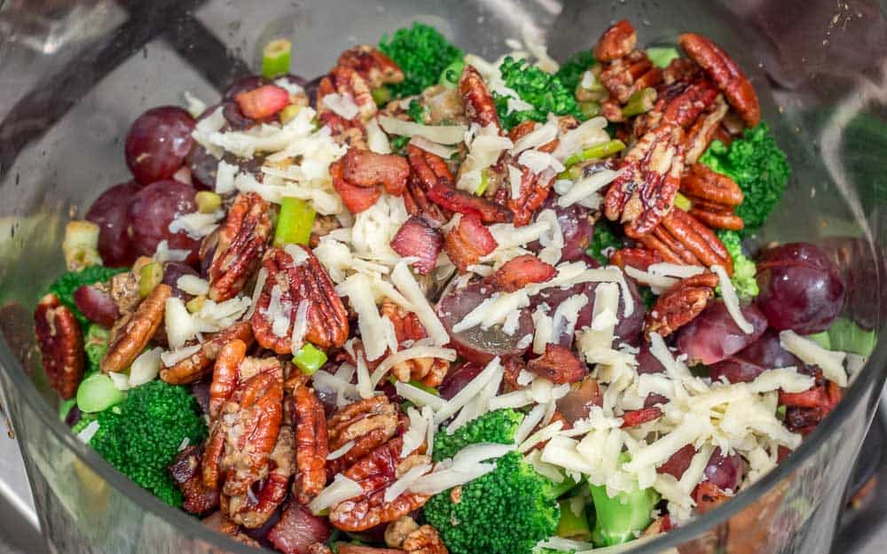 Sprinkling the cheese on the salad is the final touch, for this delicious broccoli salad with warm bacon vinaigrette. 