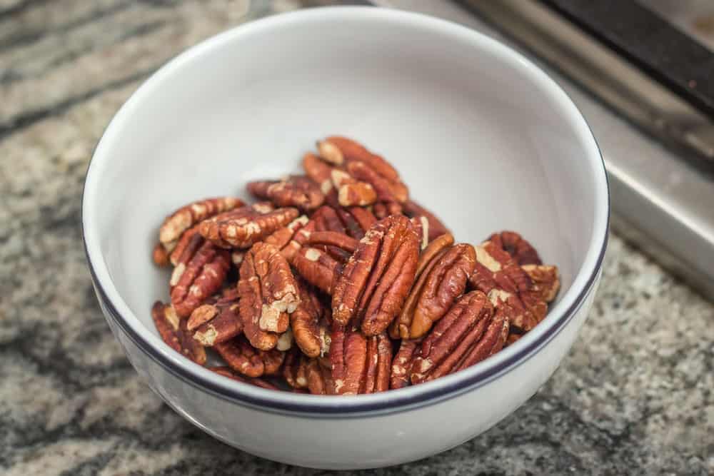 The toasted pecans, set aside in a bowl.