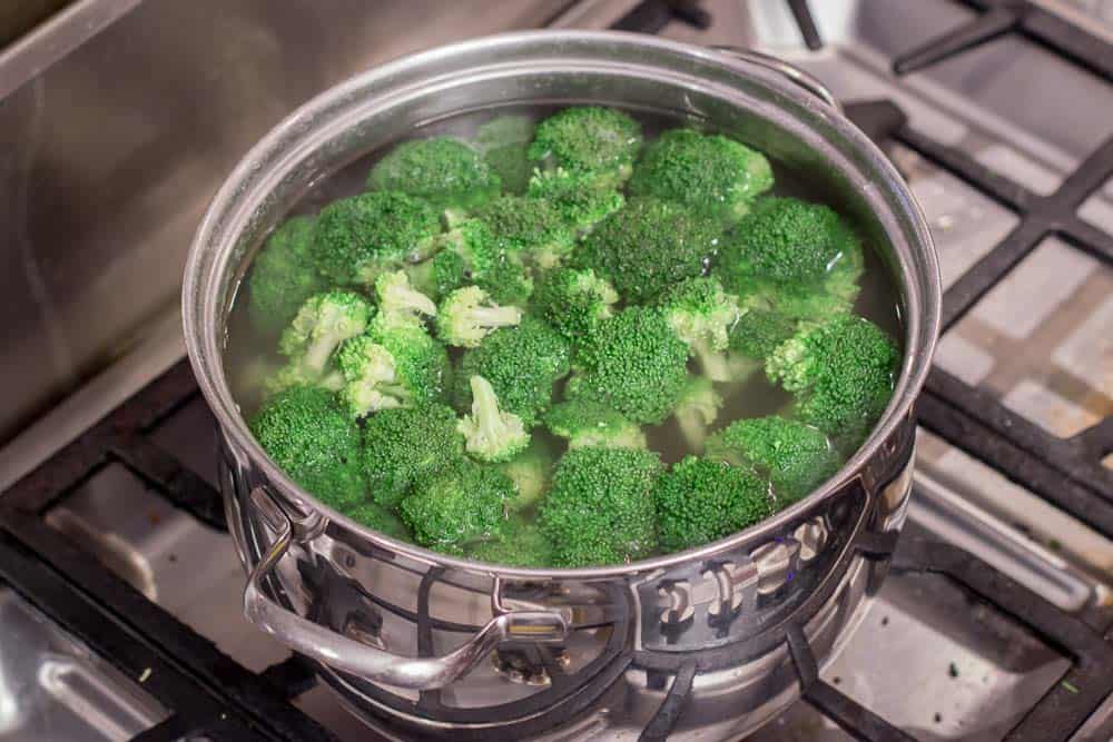 Briefly boiling broccoli.