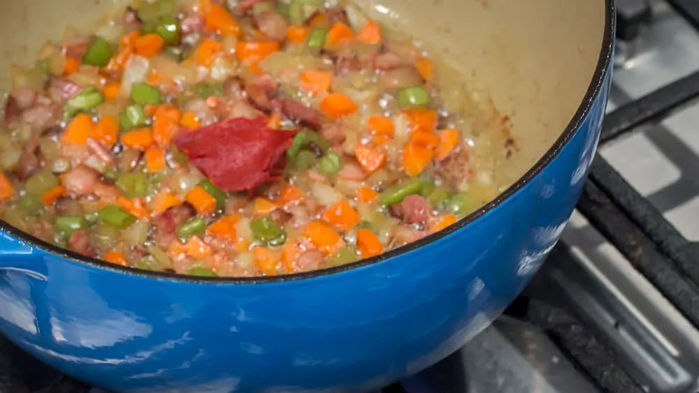 Sauté the tomato paste into the veggie mixture.