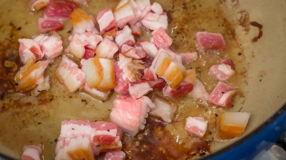 Rendering the fat from the bacon.