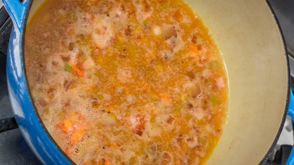 Bringing the wine mixture to a boil, and then reducing to a simmer.