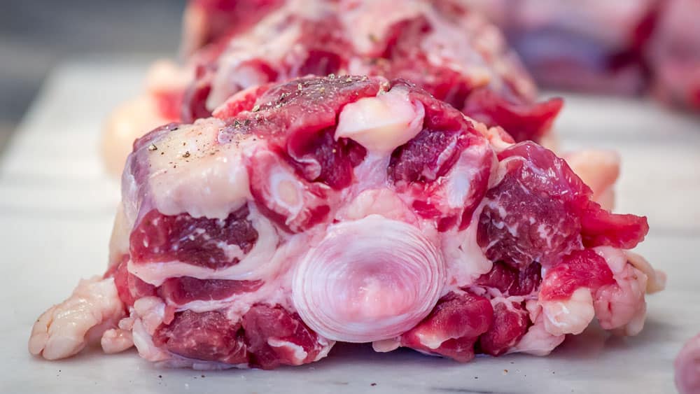 A closeup of the inner portion of a slice of oxtail. You can see the delicious marrow that makes this stew so deeply delicious.