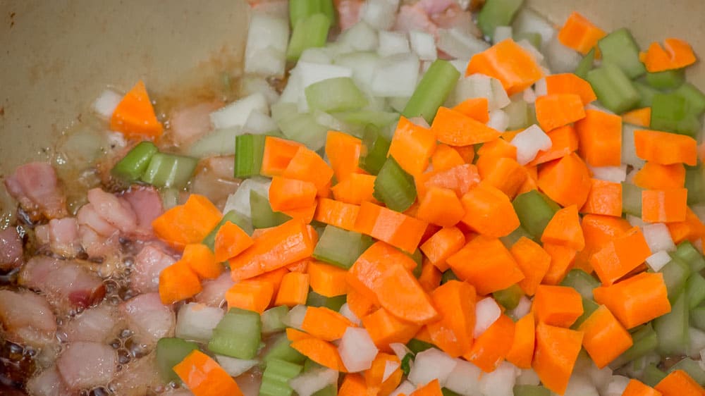 Adding the veggies to be sautéd.