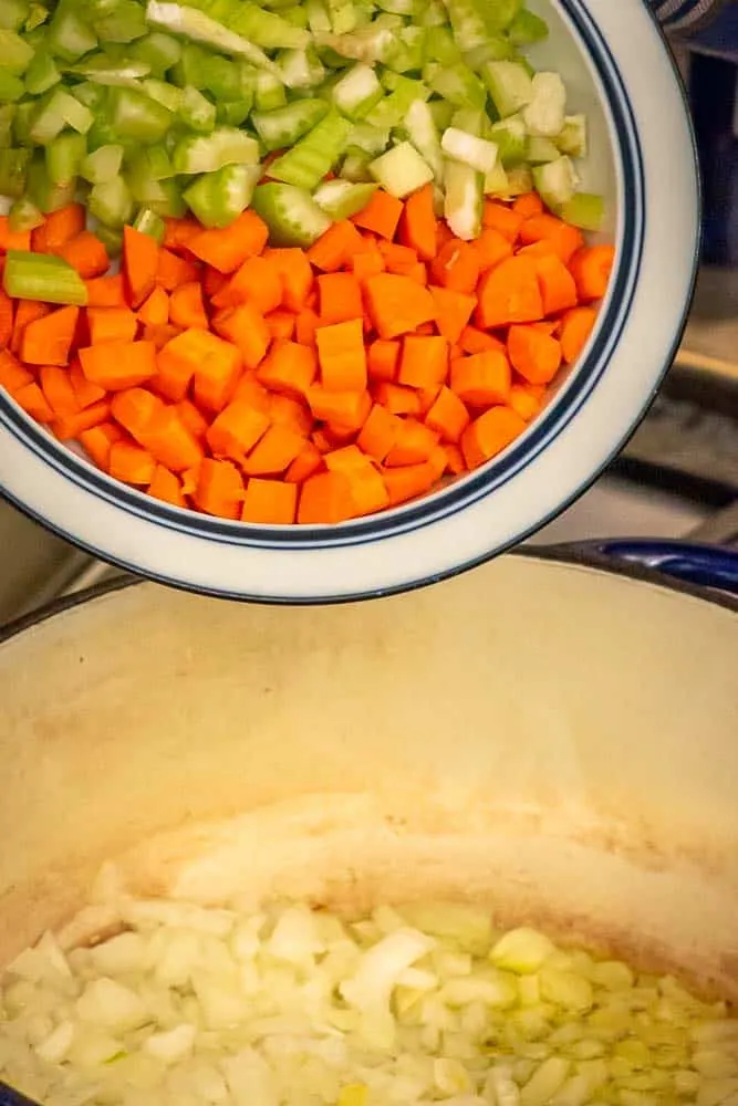 Adding the carrots and celery to the onions.