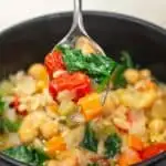 Permalink to: Orzo Soup with Chickpeas, Tomatoes, and Spinach How about a bite? The spoonful of soup is lifted toward the reader.