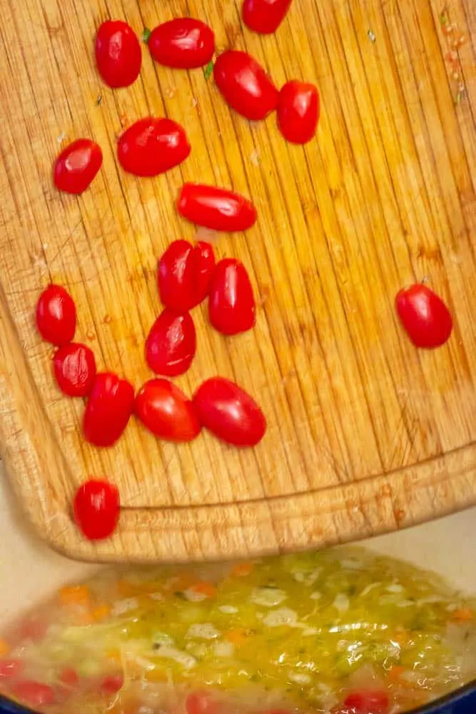 Halving the grape tomatoes.