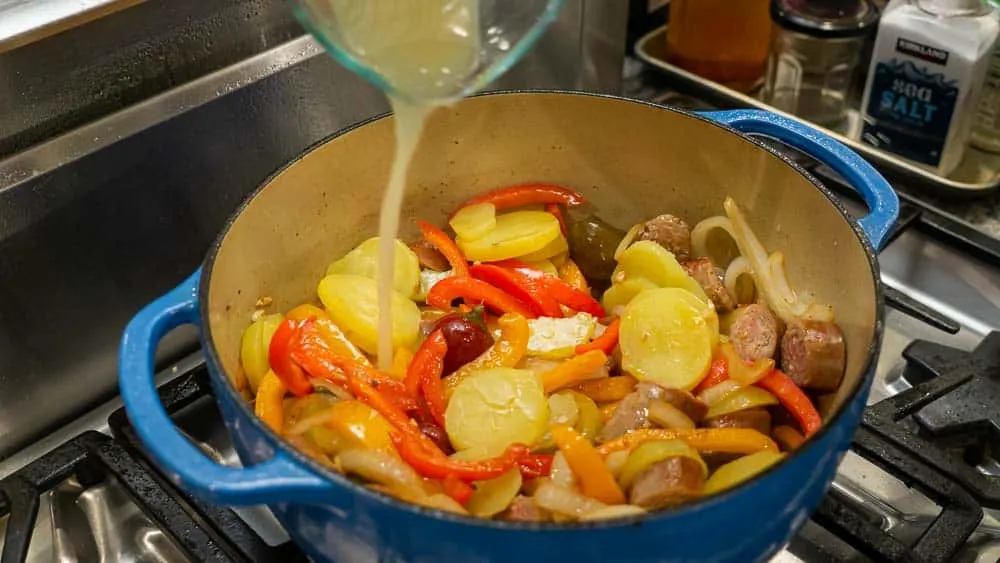 Pouring the broth into the pot.