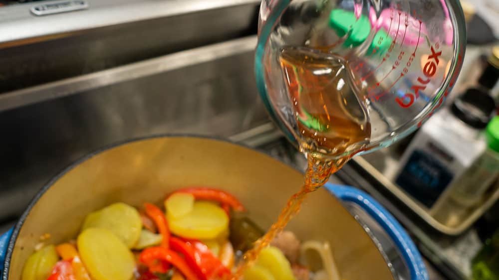 Adding the red wine vinegar to the pot.