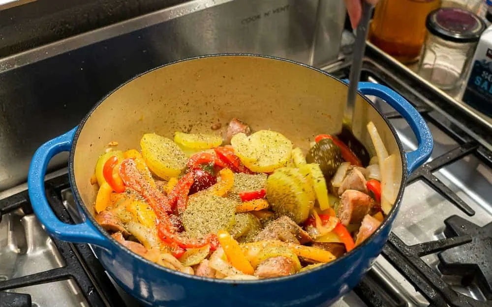 Adding the oregano to the pot.