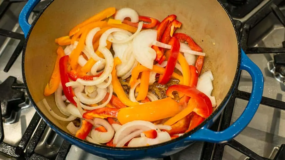 Browning the peppers and onions (and finally the garlic) in the meat fat and olive oil. 