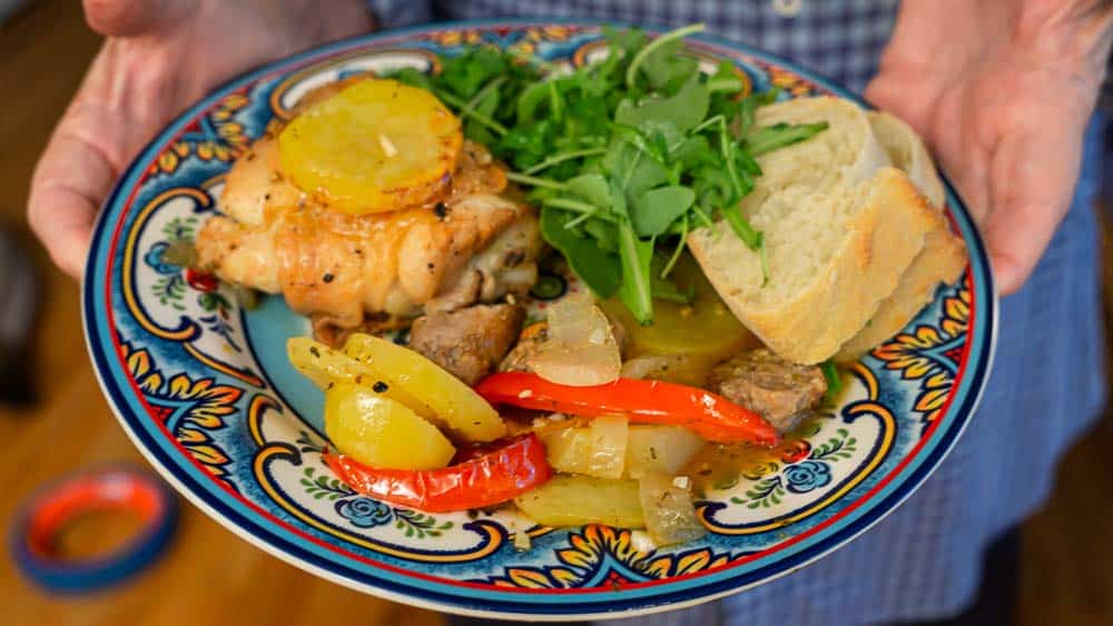 A plate of Chicken Scapariello, with salad and bread.