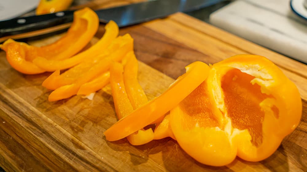 Slicing yellow bell pepper.