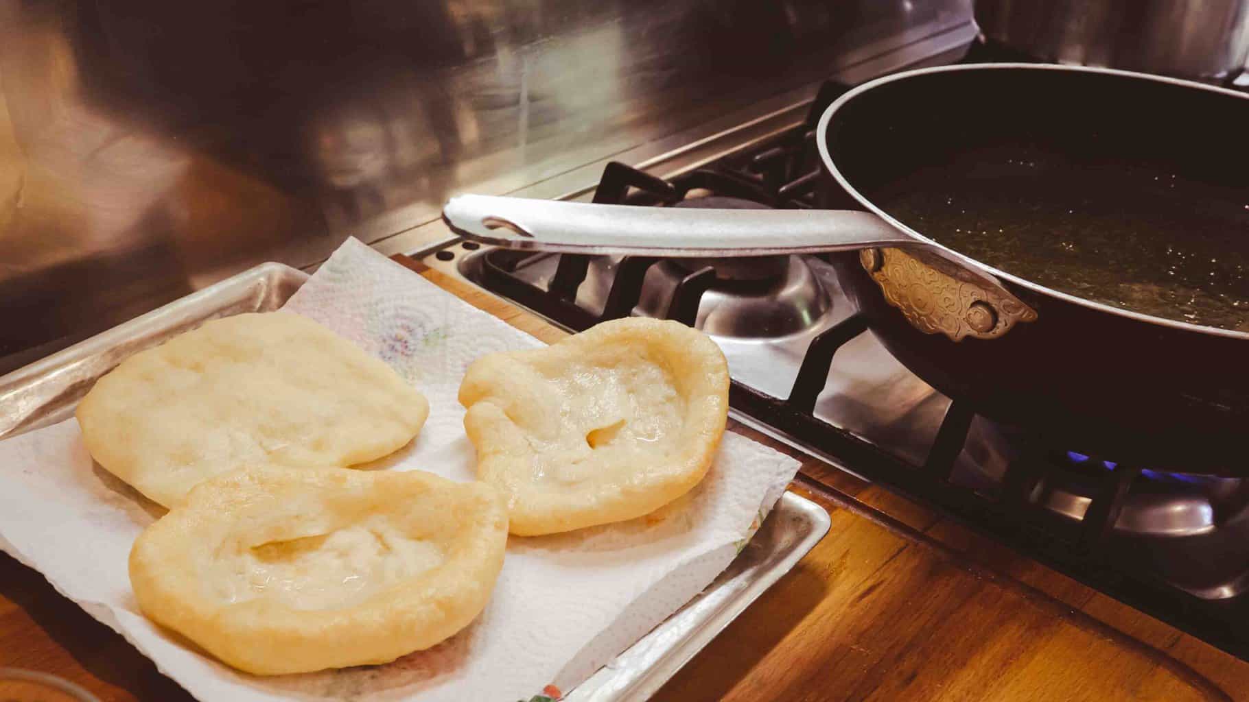 Allowing the excess oil to drain from the pizzelle crust.