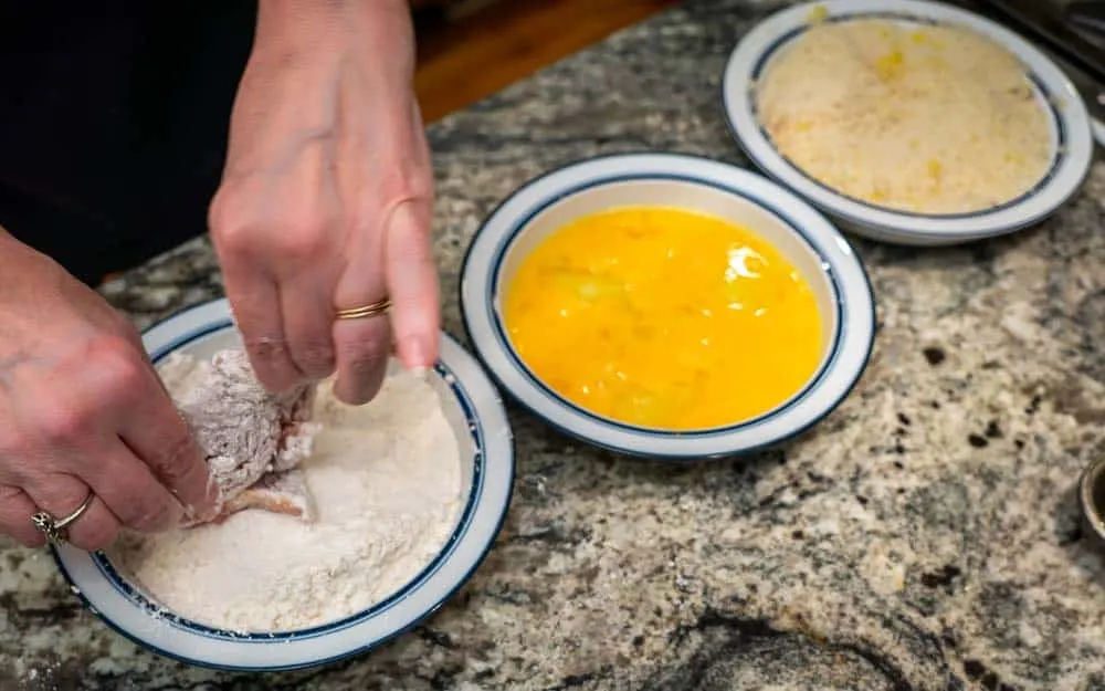 First, coat the turkey portions in flour.
