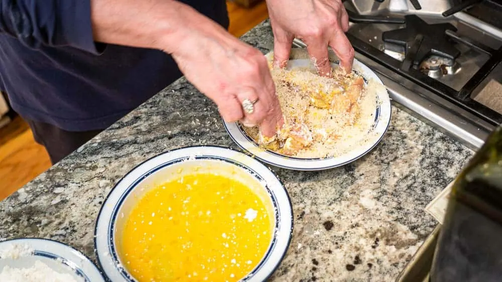 Breading the turkey in panko (crispy bread crumbs).