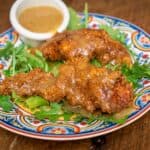 Wild Turkey Tenders with Honey Mustard Dipping Sauce on a bed of arugula.
