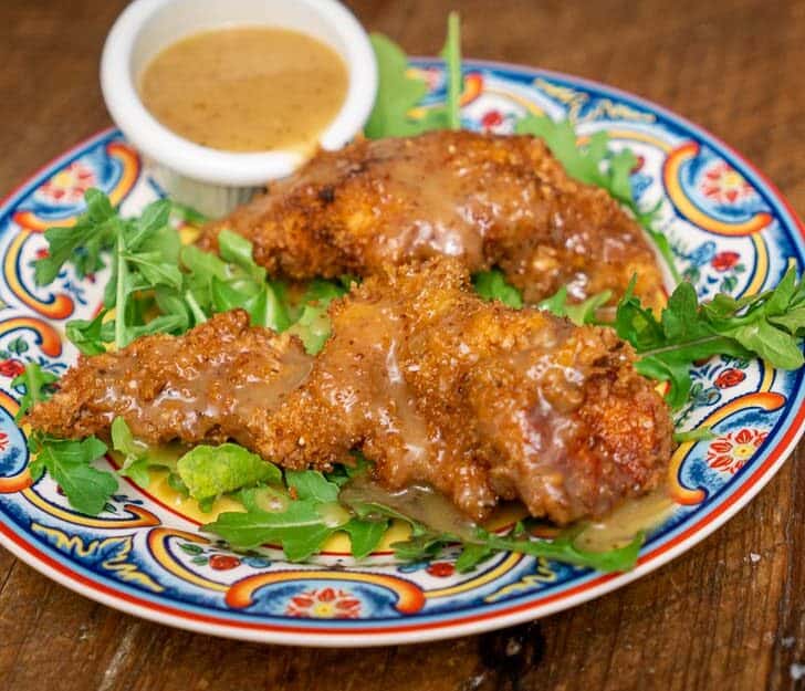 Wild Turkey Tenders with Honey Mustard Dipping Sauce on a bed of arugula.