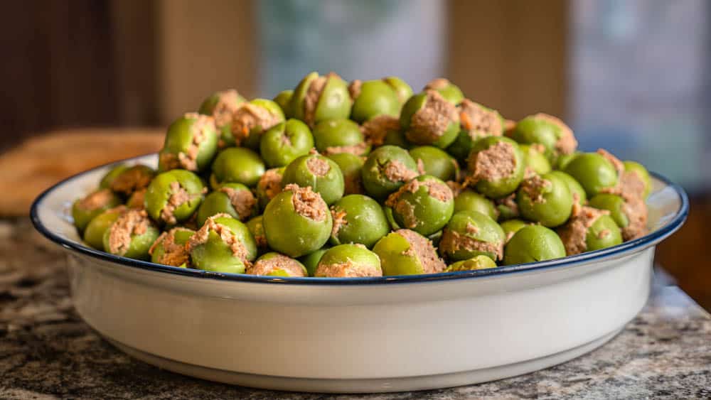 A bunch of stuffed olives, ready to be breaded.