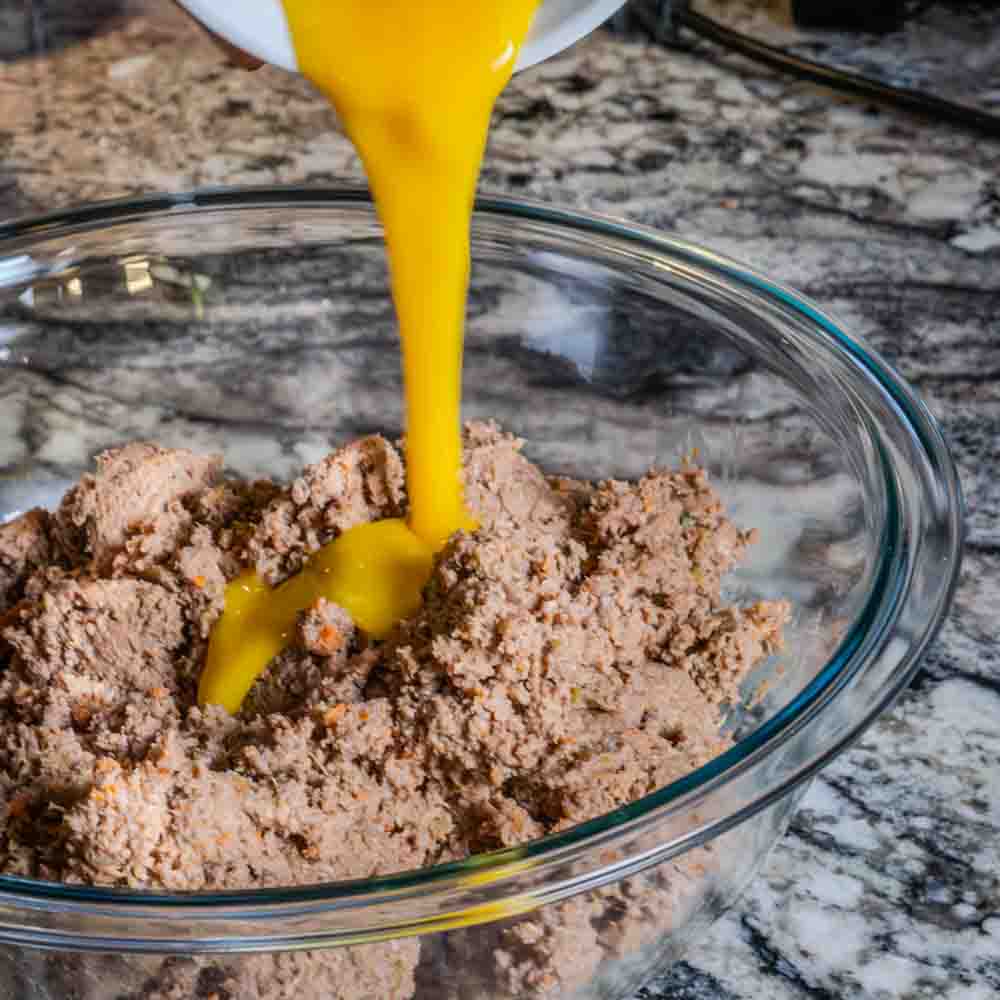 To the meat paste, we add a beaten egg, to help bind it.