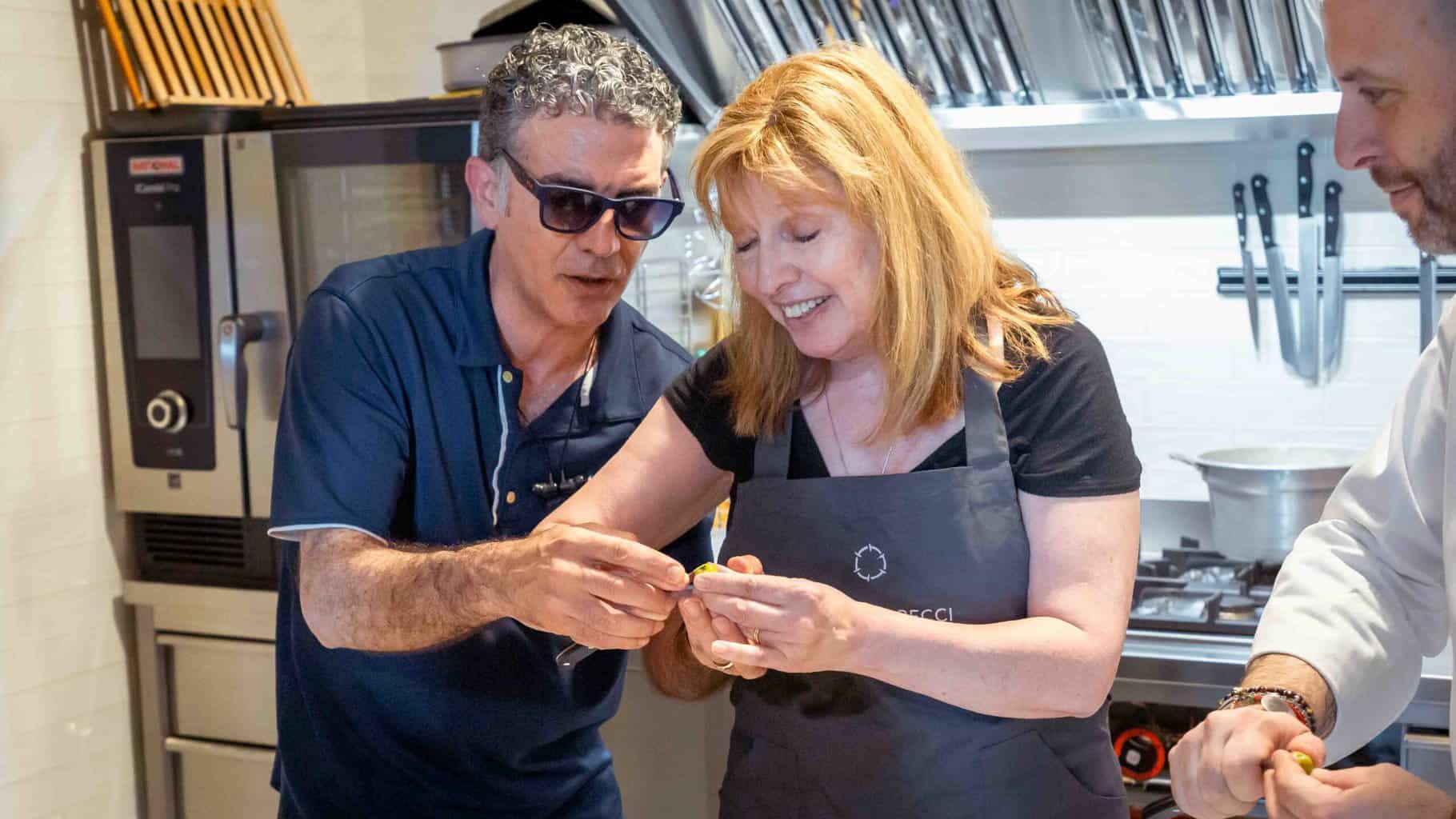 Our friend Eros, who speaks English, and who is also a trained chef, is correcting my olive cutting technique.